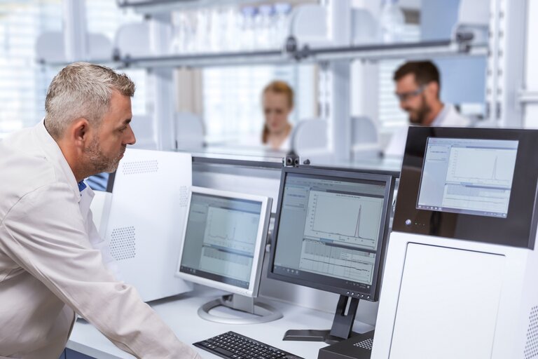 Scientist analyzing protein expression data for Pichia pastoris strain development using VALIDOGEN’s UNLOCK PICHIA® platform.