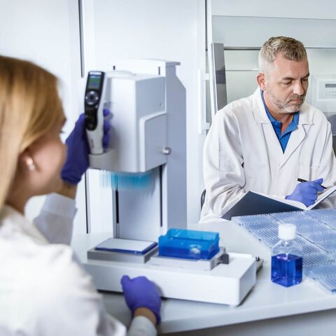 Scientists in a laboratory conducting protein expression feasibility studies using advanced equipment and VALIDOGEN's UNLOCK PICHIA® technology.