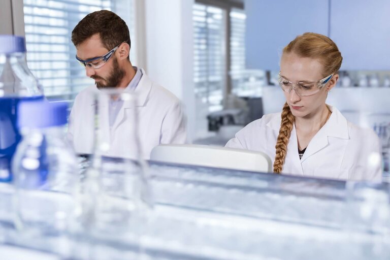 Scientists in a VALIDOGEN Pichia strain development laboratory wearing safe