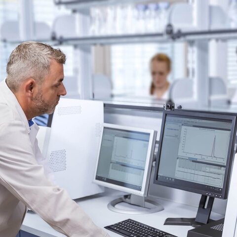 Scientist analyzing protein expression data for Pichia pastoris strain development using VALIDOGEN’s UNLOCK PICHIA® platform.